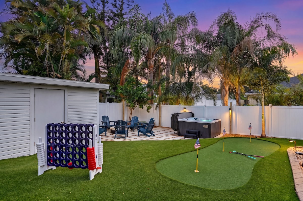 Backyard putting green, hot tub, and giant Connect Four
