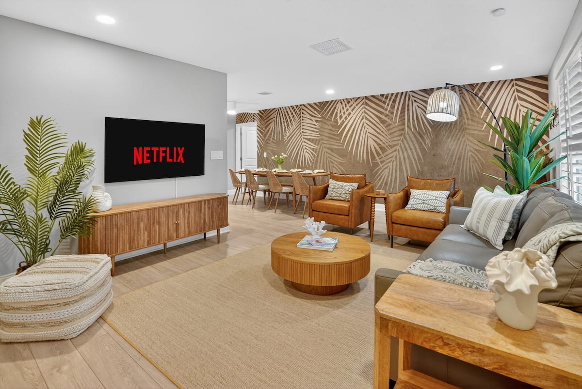 Living room with smart TV and tropical accent wall