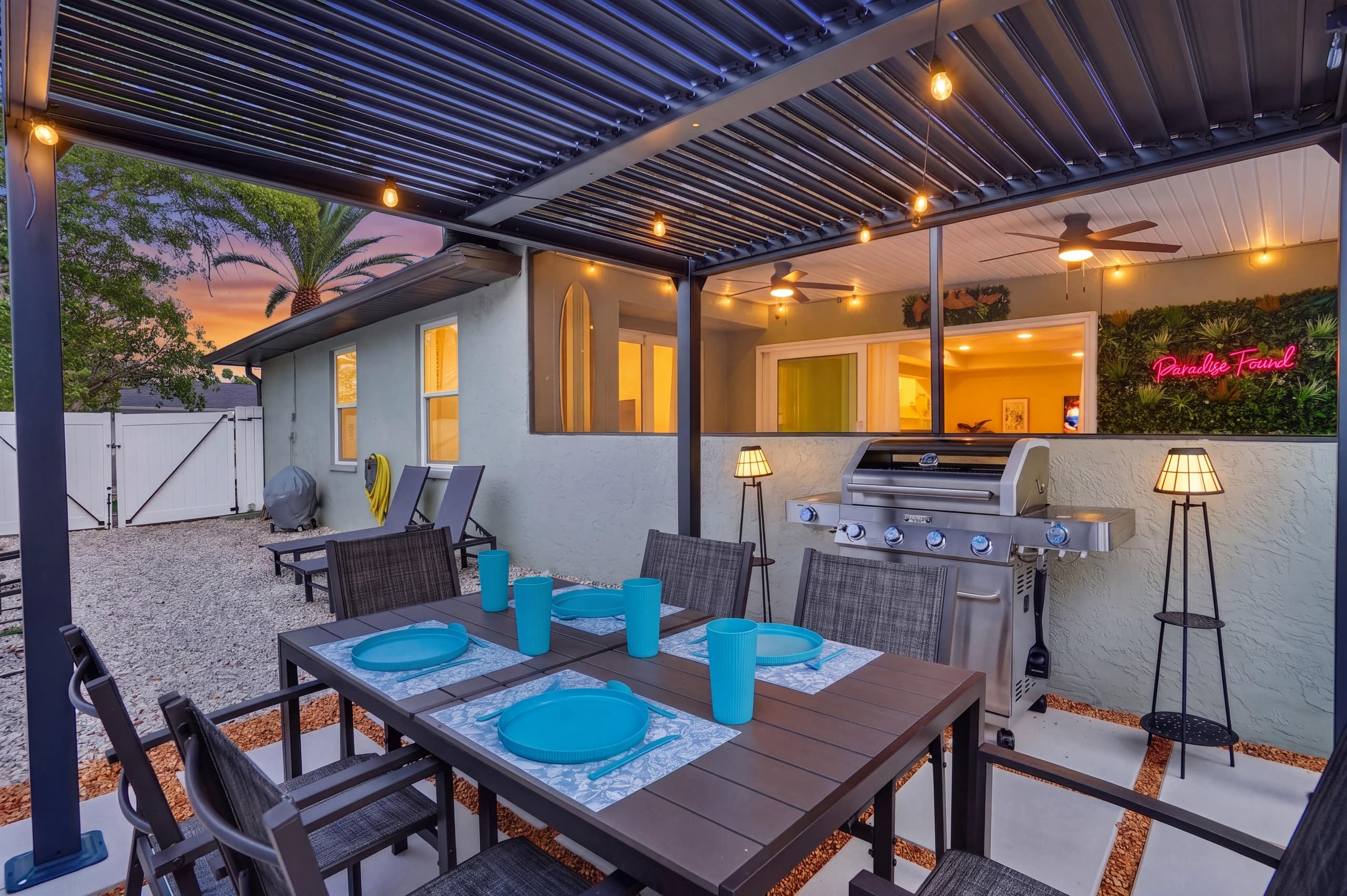 Covered patio dining area with BBQ grill